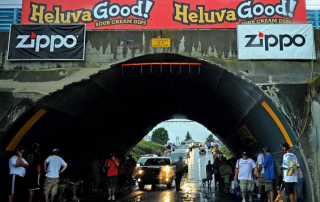 image of people inside a tunnel with zippo posters, and heluva good! posters