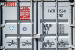 The back doors of a shipping container with "ALLEN STORAGE CONTAINER RENTALS" and weight capacity details displayed.