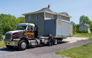Image of a delivery truck at a house with A-Verdi employees delivering a 20' storage container